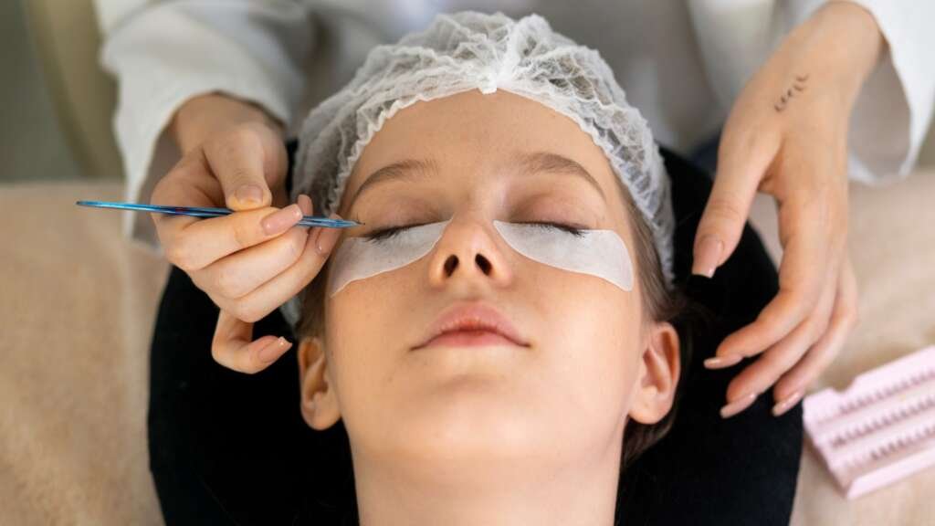 Student practicing eyelash extensions at GLAM Beauty
Academy